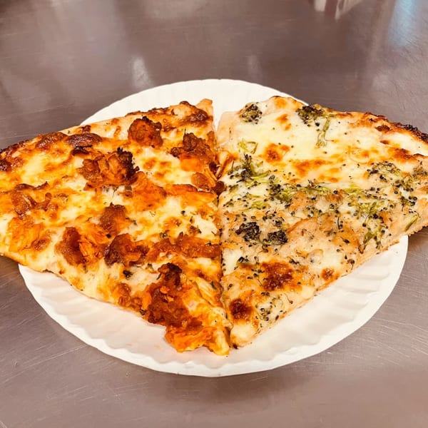 Two slices of Backwoods Pizza, one with chicken and the other with broccoli, on a paper plate.
