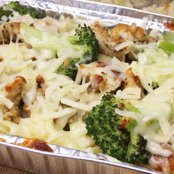 Backwoods Pizza's cheesy chicken and broccoli bake in a foil pan, ready to eat.